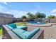 Spacious patio with wicker furniture near the pool and putting green at 1179 E Coyote Creek Way, San Tan Valley, AZ 85143