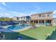 Large kidney shaped pool with spa and putting green at 1179 E Coyote Creek Way, San Tan Valley, AZ 85143