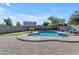 Inviting kidney-shaped pool with a spacious patio perfect for entertaining at 1179 E Coyote Creek Way, San Tan Valley, AZ 85143