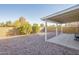 Backyard featuring desert landscaping, a covered patio for shade, and a privacy wall at 1240 W Straford Dr, Chandler, AZ 85224