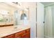 Bathroom with tiled flooring featuring a vanity and mirror with access to shower at 1240 W Straford Dr, Chandler, AZ 85224