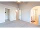 Bedroom with gray carpet featuring closet, doorway and arch to bathroom at 1240 W Straford Dr, Chandler, AZ 85224