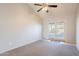 Sunlit bedroom featuring a ceiling fan and access to the outdoor area through glass doors at 1240 W Straford Dr, Chandler, AZ 85224