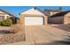 This single-Gathering home showcases a two-car garage with a brick facade and a spacious driveway at 1240 W Straford Dr, Chandler, AZ 85224