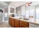 Bright kitchen with stainless steel sink, white cabinets, wood cabinets and an open layout to the dining area at 1240 W Straford Dr, Chandler, AZ 85224