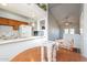 Bright kitchen featuring wooden cabinets, white appliances, and an open layout with a view into the dining area at 1240 W Straford Dr, Chandler, AZ 85224