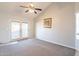 Bright and airy living room with a ceiling fan and neutral carpet, awaiting your personal touch at 1240 W Straford Dr, Chandler, AZ 85224