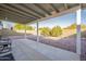 Covered patio area with chairs overlooking a low maintenance backyard with gravel and desert shrubs at 1240 W Straford Dr, Chandler, AZ 85224