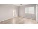 Light-filled bedroom featuring wood-look flooring at 12833 W Laurel Ln, El Mirage, AZ 85335