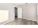 Well-lit bedroom with wood-look floors and door to bath at 12833 W Laurel Ln, El Mirage, AZ 85335