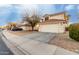 Two-story house with a two-car garage and desert landscaping at 12833 W Laurel Ln, El Mirage, AZ 85335