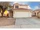 Two-story house with a two-car garage and desert landscaping at 12833 W Laurel Ln, El Mirage, AZ 85335