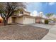 Two-story house with a two-car garage and desert landscaping at 12833 W Laurel Ln, El Mirage, AZ 85335