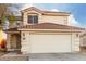 Two-story house with a two-car garage and desert landscaping at 12833 W Laurel Ln, El Mirage, AZ 85335