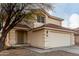 Two-story house with a two-car garage and desert landscaping at 12833 W Laurel Ln, El Mirage, AZ 85335