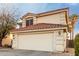 Two-story house with a two-car garage and desert landscaping at 12833 W Laurel Ln, El Mirage, AZ 85335