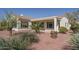 Home's backyard with covered patio and desert landscaping at 13403 W Cabrillo Dr, Sun City West, AZ 85375