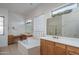 Elegant bathroom with double vanity and soaking tub at 13403 W Cabrillo Dr, Sun City West, AZ 85375