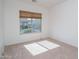 Well-lit bedroom with a large window and neutral decor at 13403 W Cabrillo Dr, Sun City West, AZ 85375