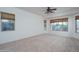 Bright bedroom with neutral carpeting and large windows at 13403 W Cabrillo Dr, Sun City West, AZ 85375