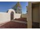 Private courtyard with arched gate and gravel pathway at 13403 W Cabrillo Dr, Sun City West, AZ 85375