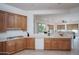 Kitchen with wood cabinets, view into Gathering room at 13403 W Cabrillo Dr, Sun City West, AZ 85375