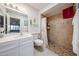 Tiled bathroom showcasing a vanity, toilet, and a separate tiled shower area at 13861 N 111Th Ave, Sun City, AZ 85351