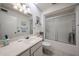 Bright bathroom featuring a vanity, toilet, and a shower with glass doors at 13861 N 111Th Ave, Sun City, AZ 85351