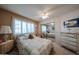 Bedroom with natural light streaming in, a plush carpet, and a decorative mirror at 13861 N 111Th Ave, Sun City, AZ 85351