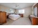 Well-lit bedroom with carpet flooring, a ceiling fan, and neutral-colored walls at 13861 N 111Th Ave, Sun City, AZ 85351