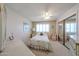 Cozy bedroom with a ceiling fan, plush carpet, and a sliding mirror door closet at 13861 N 111Th Ave, Sun City, AZ 85351