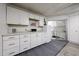 Well-lit garage features cabinets, counter space, and access to laundry area at 13861 N 111Th Ave, Sun City, AZ 85351