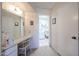 Hallway leading to a bathroom with a vanity area and a separate door to the toilet at 13861 N 111Th Ave, Sun City, AZ 85351