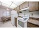 Bright kitchen area with white appliances and an adjacent breakfast nook at 13861 N 111Th Ave, Sun City, AZ 85351