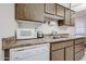 Convenient kitchen area with stainless steel sink and ample counter space at 13861 N 111Th Ave, Sun City, AZ 85351