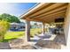 A covered outdoor patio with a dining table that overlooks the backyard, with the pool and gazebo at 16302 N 36Th Ave, Phoenix, AZ 85053