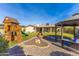 Expansive backyard featuring a playset, a cozy gazebo, and a rock feature, creating a Gathering-friendly oasis at 16302 N 36Th Ave, Phoenix, AZ 85053