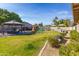 A large backyard with a well manicured lawn, pool, play structure, and an outdoor gazebo at 16302 N 36Th Ave, Phoenix, AZ 85053