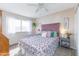 Bright bedroom features a ceiling fan and a floral bedspread, creating a cozy and inviting space at 16302 N 36Th Ave, Phoenix, AZ 85053