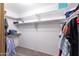 Walk-in closet features white shelving with clothing and shoes neatly displayed at 16302 N 36Th Ave, Phoenix, AZ 85053