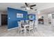 Dining room with stylish blue accent wall, ceiling fan, and views into the living area at 16302 N 36Th Ave, Phoenix, AZ 85053