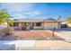 Lovely home with desert landscaping, attached two-car garage, and stepping stone pathway at 16302 N 36Th Ave, Phoenix, AZ 85053