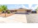 Welcoming single-story home with a well-kept front yard, spacious driveway, and attached two-car garage at 16302 N 36Th Ave, Phoenix, AZ 85053