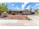 Inviting single-story home with brick accents, well-maintained desert landscaping, and a cozy, gated front porch at 16302 N 36Th Ave, Phoenix, AZ 85053