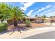 Charming single-story home featuring a manicured front yard with desert landscaping and mature palm trees at 16302 N 36Th Ave, Phoenix, AZ 85053