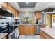 Kitchen with stainless steel appliances, light wood cabinetry, and a garden view through the window above the sink at 16302 N 36Th Ave, Phoenix, AZ 85053