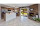 Well-lit kitchen featuring stainless steel appliances, tile flooring, and a brick fireplace at 16302 N 36Th Ave, Phoenix, AZ 85053