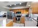 Bright kitchen features stainless steel appliances, tile floors, and a decorative tin ceiling at 16302 N 36Th Ave, Phoenix, AZ 85053