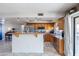 Well-lit kitchen with stainless steel appliances and breakfast bar, open to dining area at 16302 N 36Th Ave, Phoenix, AZ 85053