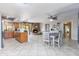 Open-concept living space with tile flooring, a brick fireplace, and views into the kitchen at 16302 N 36Th Ave, Phoenix, AZ 85053